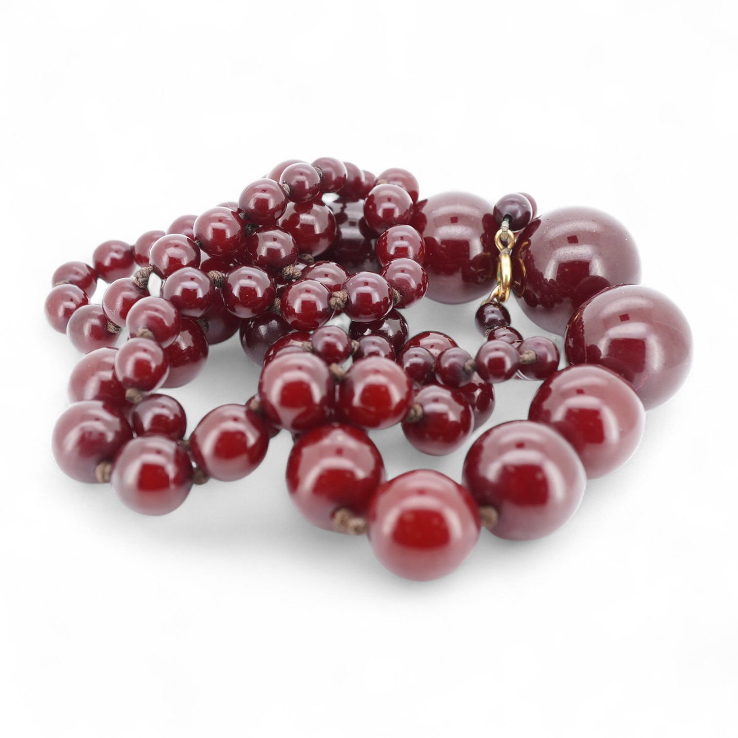 A cherry bakelite 'amber' necklace, composed of graduated spherical beads measuring approximately 6.7-23mm diameter, length approximately 86cm, gross weight 72 grams.